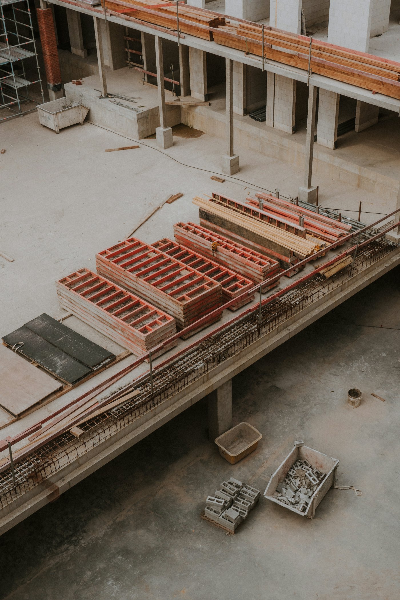 Concrete floors, formwork and materials within a building under construction.